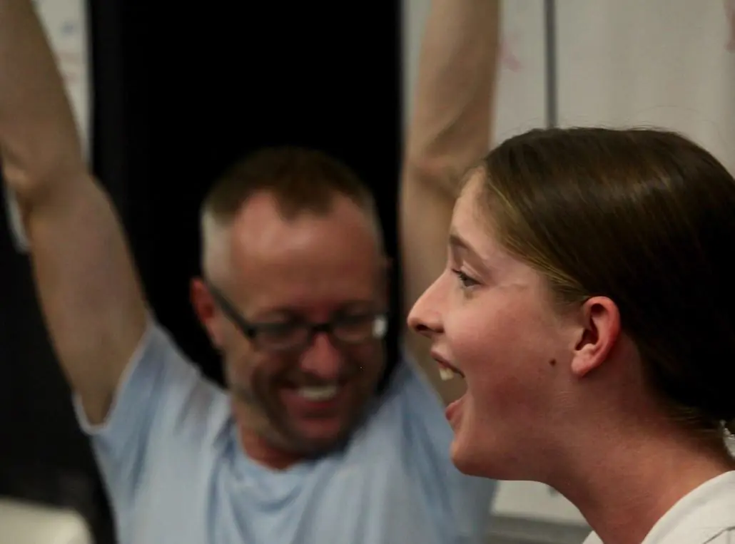 David Jayden Anthony celebrating with a student during a singing lesson